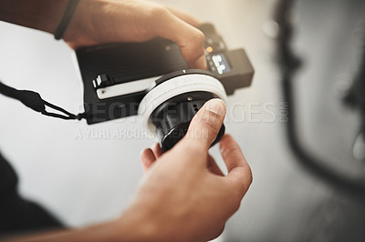 Buy stock photo Behind the scenes over the shoulder shot of an unrecognizable person operating state of the art video camera equipment inside of a studio