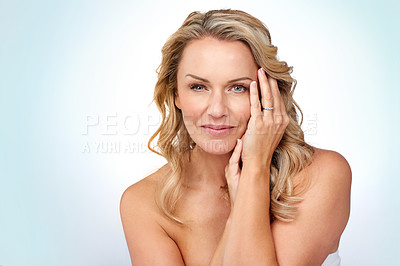 Buy stock photo Studio portrait of an attractive mature woman posing against a grey background