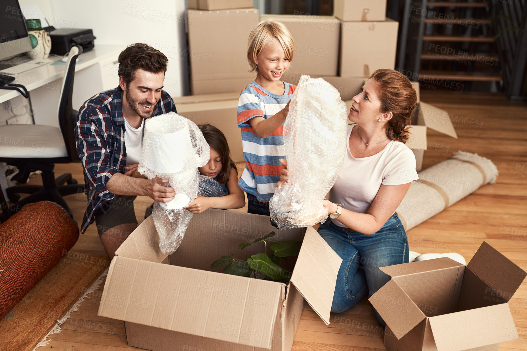 Buy stock photo Shot of a young family on their moving day