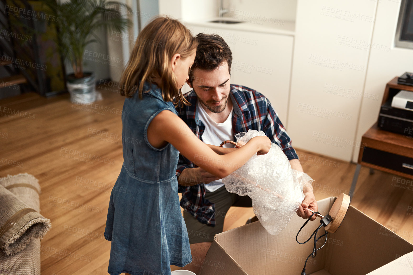 Buy stock photo Happy family, new home and property investment with boxes, moving in and apartment. Man, children and unpacking with trust, care and milestone for growth, bonding and loan for mortgage in real estate