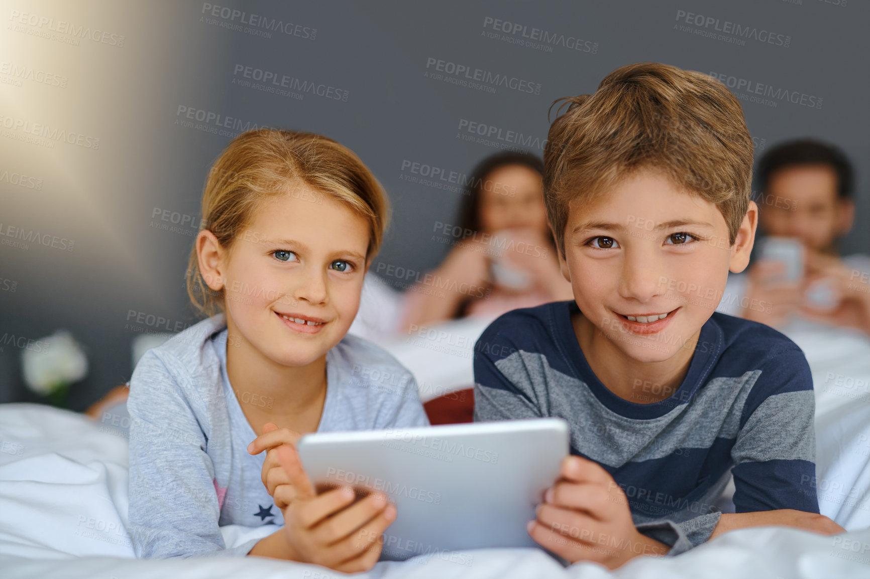 Buy stock photo Children, tablet and portrait on bed in home for education games, watching cartoon or siblings bonding. Kids, digital app or happy with parents in bedroom for online video, streaming service and play