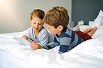 Sis and bro chilling on the bed with some wifi