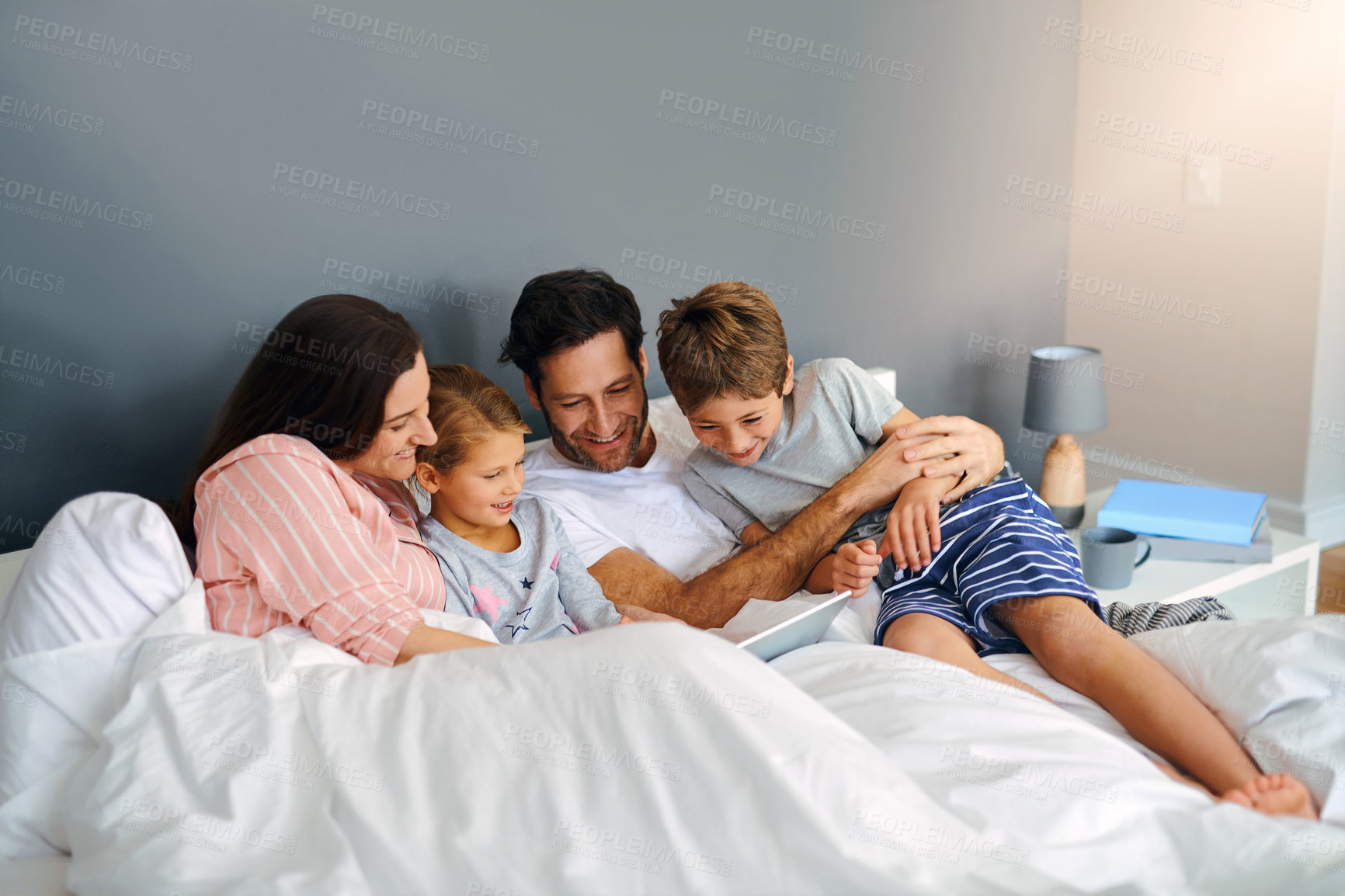 Buy stock photo Parents, kids and tablet in home for relax, bonding and playing games together on bed with support. Family, children and technology in apartment for streaming film, people and movie with subscription