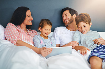 Buy stock photo Family, smile and tablet in home for relax, internet and playing game together in bed with support. Parents, kids and technology in apartment for streaming film, bonding and movie with development