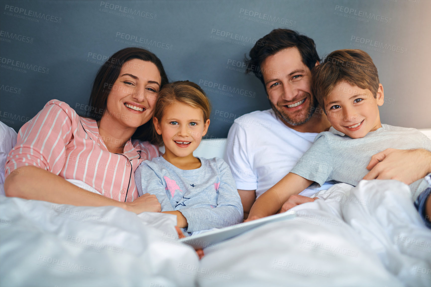 Buy stock photo Family, portrait and tablet in home for relax, internet and playing game together in bed with support. Parents, kids and technology in apartment for streaming film, weekend and movie with development