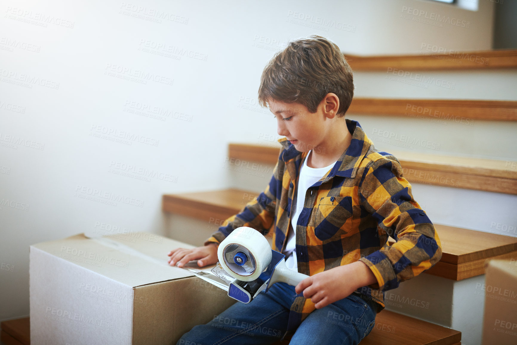 Buy stock photo Packing, moving and child with tape for boxes on stairs for new start, real estate or property investment. Change, male kid and boy with cardboard for relocation, helping or seal on package in home