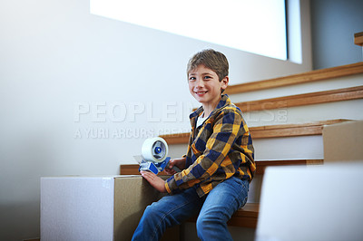 Buy stock photo Cropped shot of an adorable little boy packing boxes on moving day