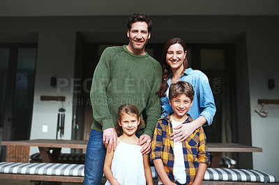 Buy stock photo Portrait of a young family in the backyard at home