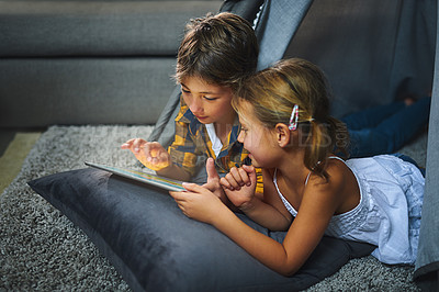 Buy stock photo Tablet, relax and children in tent in home playing online educational game for learning. Rest, digital technology and kid siblings watching video for entertainment in blanket fort for fun at home.