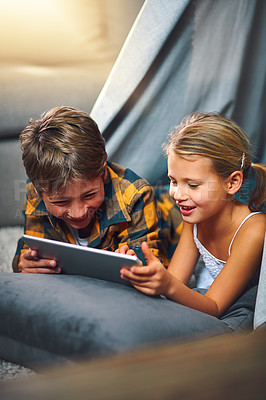 Buy stock photo Tablet, happy and children in tent in home playing online educational game for learning. Relax, digital technology and kid siblings watching video for entertainment in blanket fort for fun at home.