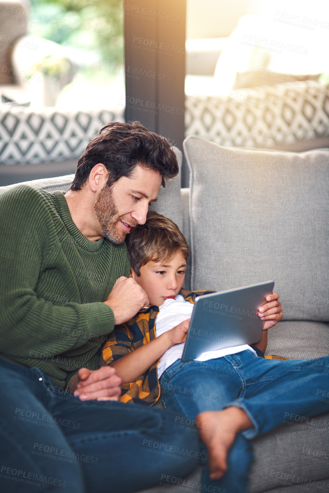 Buy stock photo Father, boy kid and tablet on sofa in home for educational games, watching cartoon and bonding. Love, man and son with digital app on couch in lounge for online video and streaming service in house