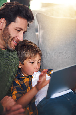 Buy stock photo Father, boy child and tablet on sofa in home for educational games, watching cartoon and bonding. Love, man and son with digital app on couch in lounge for online video and streaming service in house