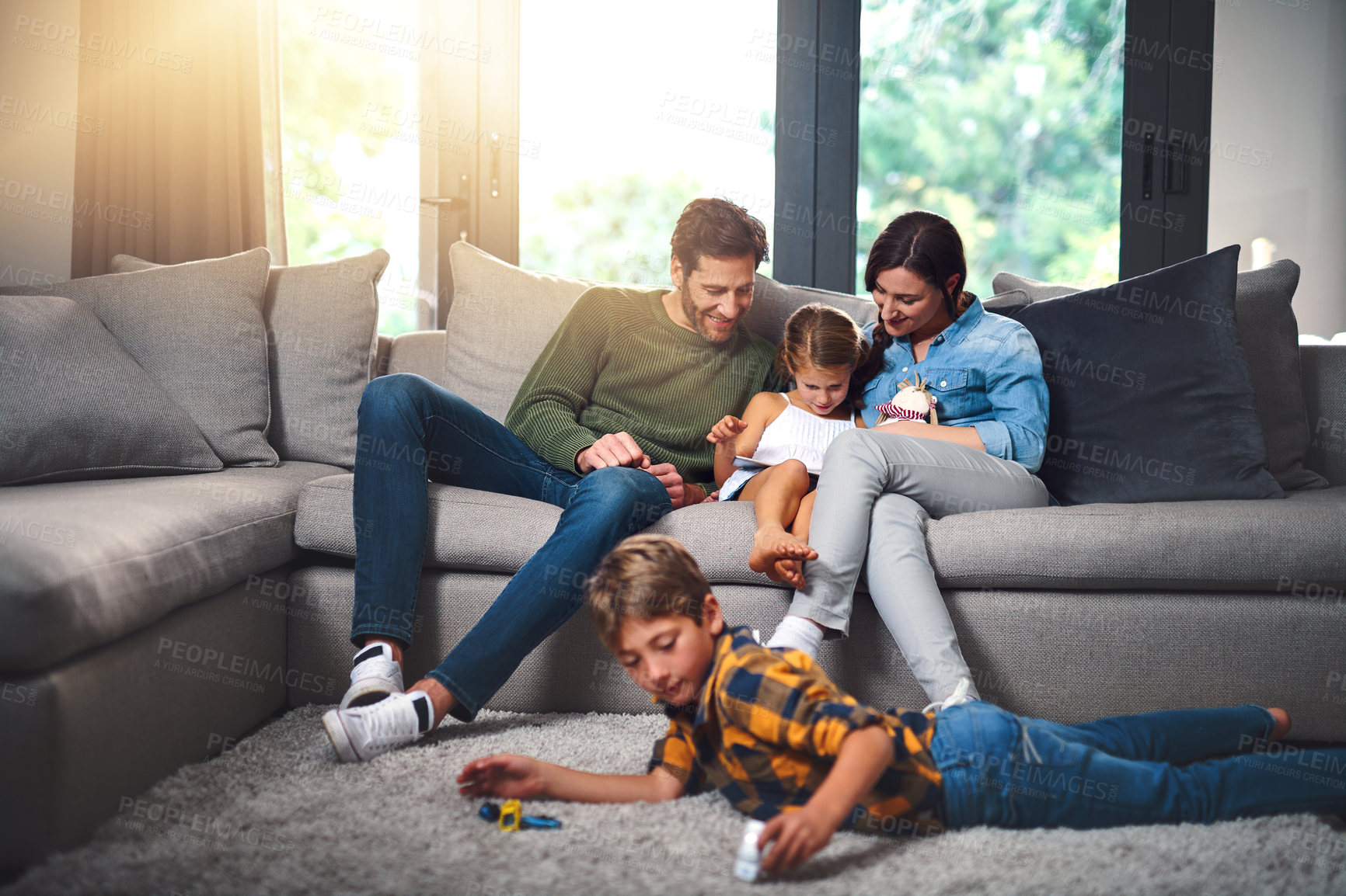 Buy stock photo Parents, children and relax in home with tablet, games or comfort on lazy weekend. Kids, family and technology on living room sofa for creativity, playful boy and relationship development or growth