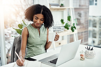 Buy stock photo Black woman, writing and office research at laptop as journalist with notebook, creative or project planning. Female person, smile and coffee up in startup agency for brief, review or brainstorming