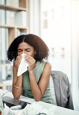 Buy stock photo Cropped shot of an attractive young businesswoman blowing her nose while sitting at her desk in the office