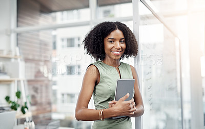 Buy stock photo Cropped portrait of an attractive young businesswoman standing in her office with a tablet in hand
