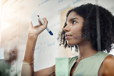 Buy stock photo Glass wall, black woman and writing, planning or strategy in office workplace. Brainstorming, board and African business person write, working on project and schedule, sticky notes or information.
