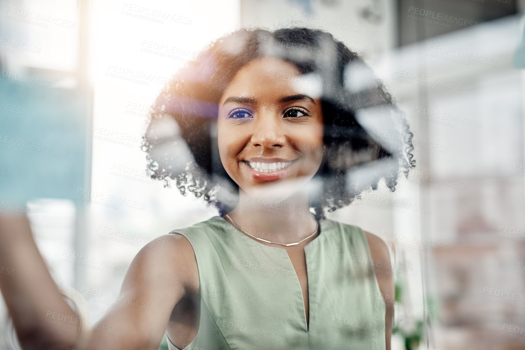 Buy stock photo Cropped shot of an attractive young businesswoman working on a glass wipe board in her office