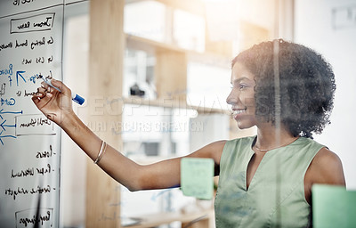 Buy stock photo Cropped shot of an attractive young businesswoman working on a glass wipe board in her office
