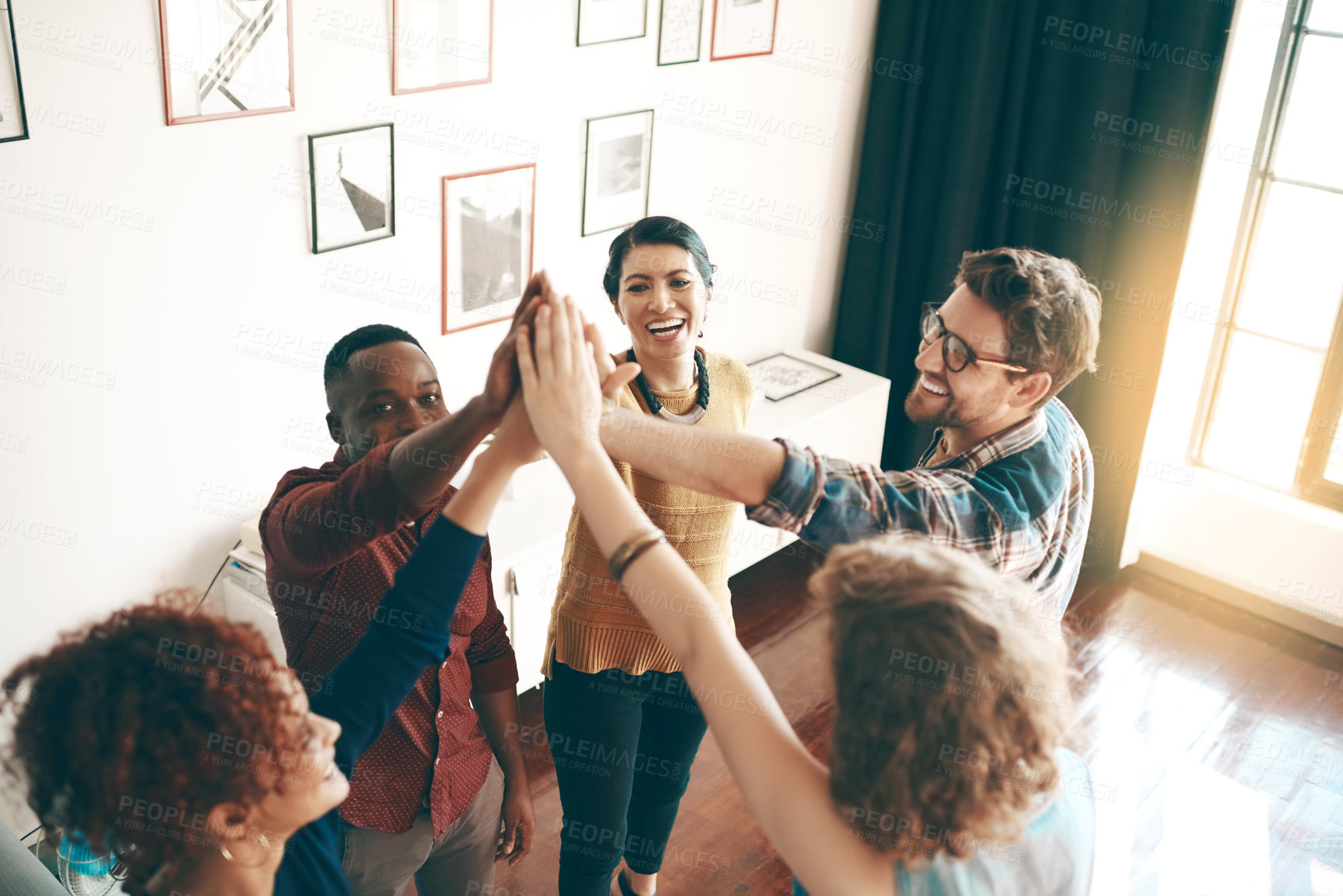 Buy stock photo Designers, high five and happy in studio for teamwork, support and inclusion in design agency. Creative team, huddle or hand gesture in workplace for synergy, collaboration or excited for opportunity