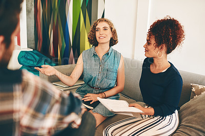 Buy stock photo Shot of a group of designers having a discussion in an office