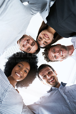 Buy stock photo Portrait of a group of businesspeople joining their heads together in a huddle