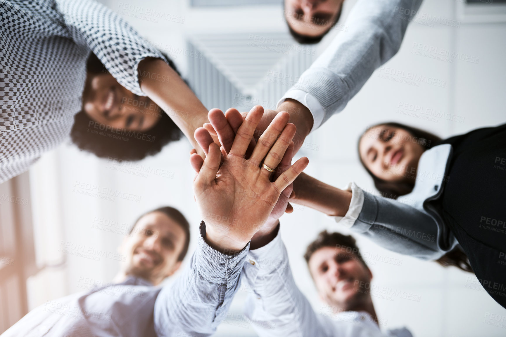 Buy stock photo Closeup shot of a group of businesspeople joining their hands together in a huddle