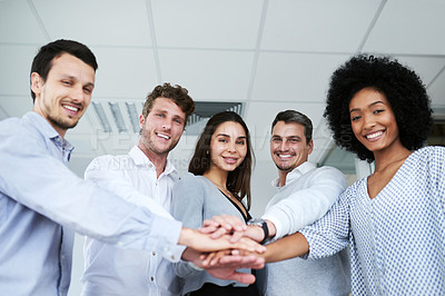 Buy stock photo Portrait of a group of businesspeople joining their hands together in a huddle