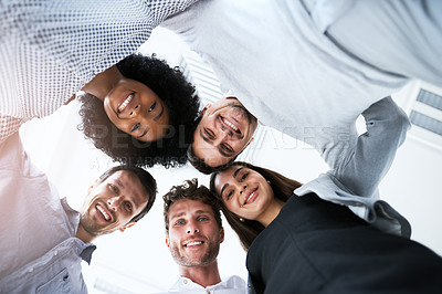 Buy stock photo Portrait of a group of businesspeople joining their heads together in a huddle