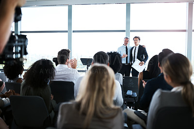Buy stock photo Shot of businesspeople applauding a colleague during a conference in an office