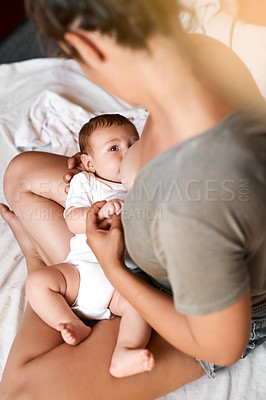 Buy stock photo Mom, baby and breastfeeding on bed for development growth, nutrition or digestive health in bedroom . Lens flare, top view and woman with newborn child for natural milk, wellness or bonding in home