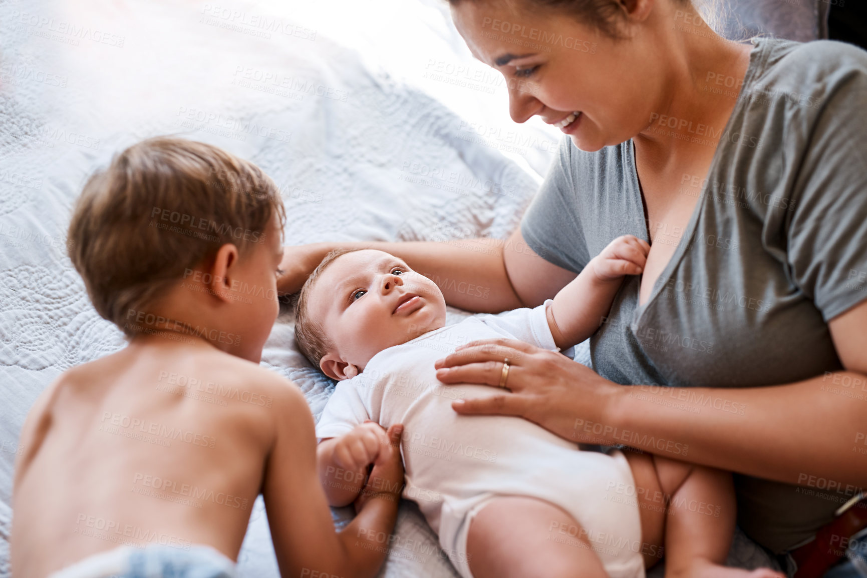 Buy stock photo Family, mom and boy children on bed for bonding together, baby support and growth in home. Mother, newborn child and young kid on mattress for development, love relationship and care for siblings