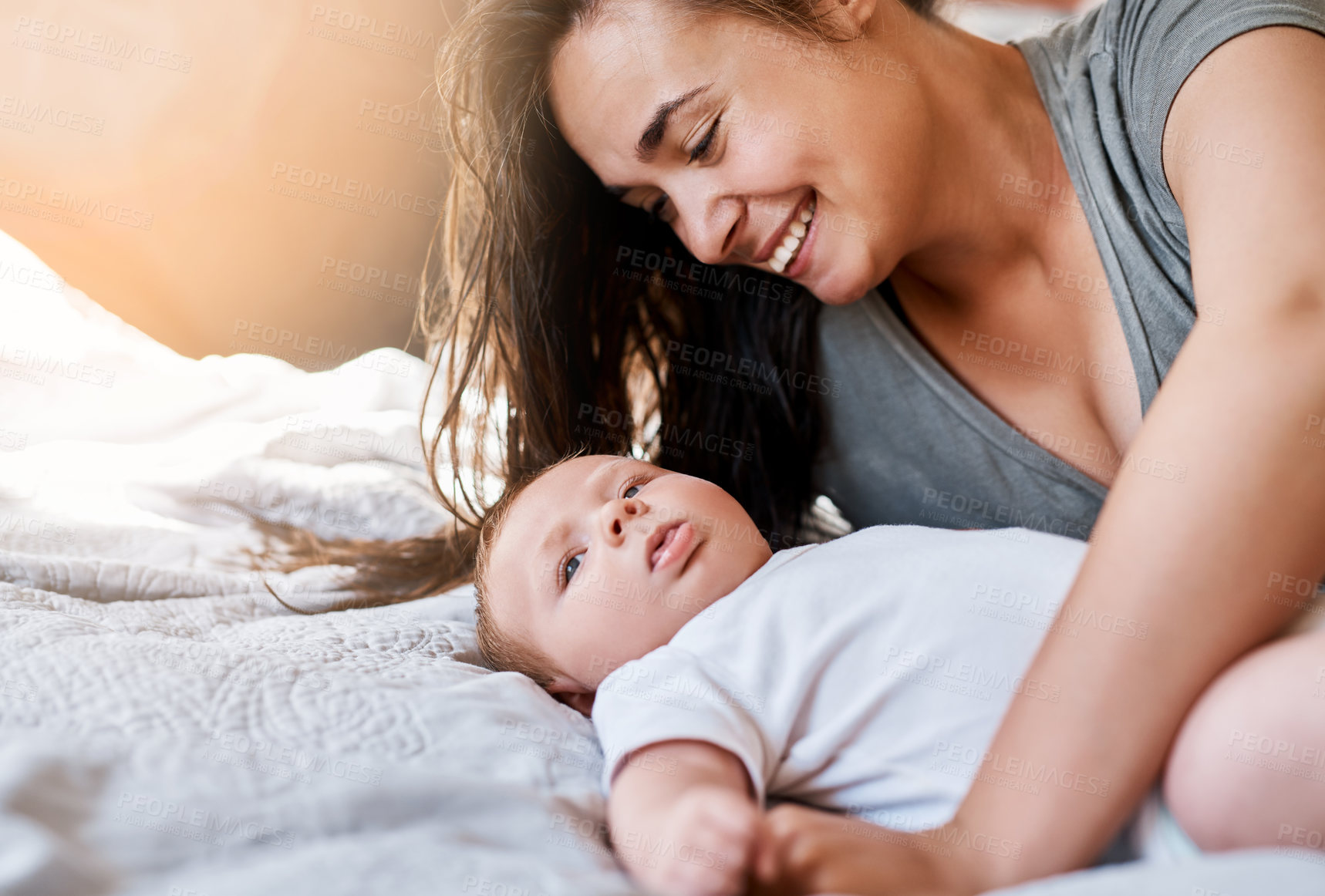 Buy stock photo Love, mom and baby in bed at home for relax, rest and bonding together as family. Happy people, mother and boy infant in bedroom for embrace with care, support or playful as parent in apartment