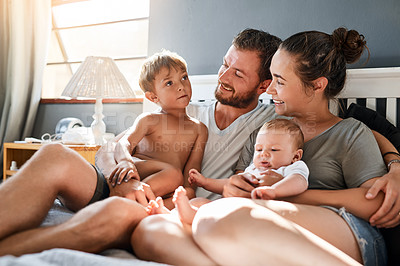 Buy stock photo Father, mother and kids in bed in home for relax, rest and bonding together as family. Happy people, parents or children in bedroom for playing with care, support or security in apartment with smile