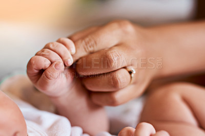 Buy stock photo Baby, hands and holding fingers with mother in house, wellness and security together for family bonding with newborn. Bedroom, people and relax with infant for care, childhood and growth with love