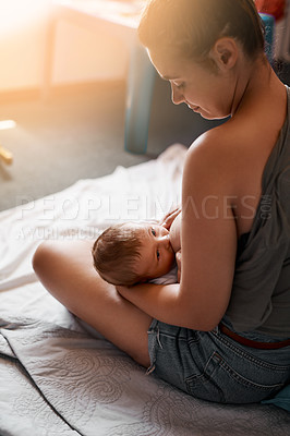 Buy stock photo Breastfeeding, mother and baby on bed in bedroom for nutrition, growth development or digestive health. Lens flare, back and woman with newborn child for natural milk, wellness or bonding in home