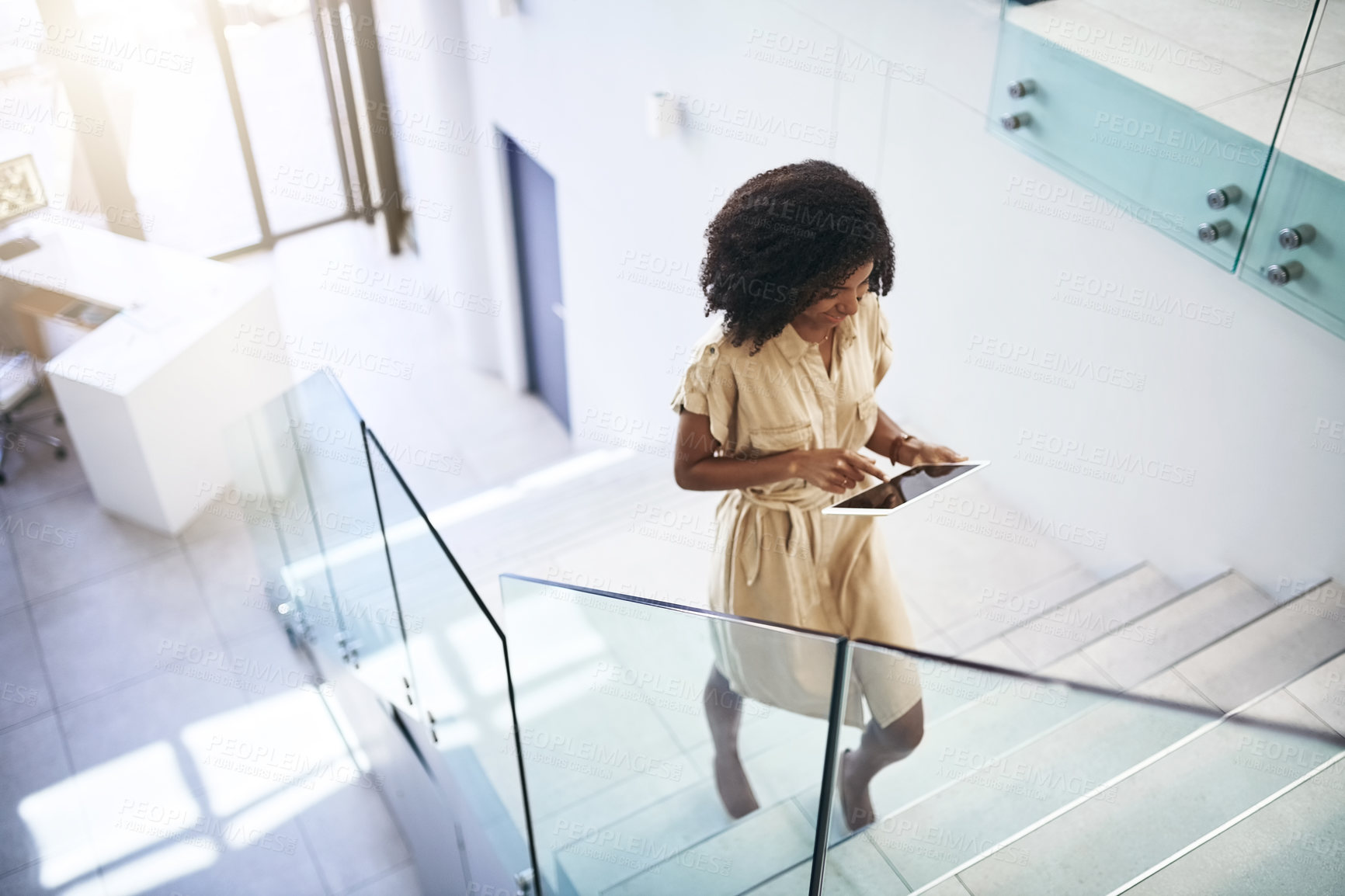 Buy stock photo Black woman, tablet and walking on stairs for communication, networking and check schedule. Female person, technology and steps with social media, conversation and online meeting calendar for work