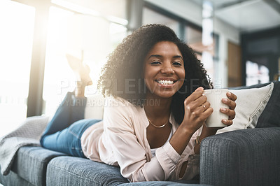 Buy stock photo Shot of an attractive young woman relaxing at home