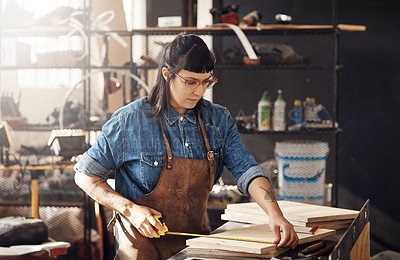 Buy stock photo Cropped shot of an attractive young woman working in her creative workshop