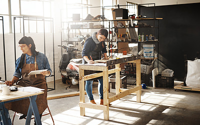 Buy stock photo Cropped shot of two attractive young creative female artisans working in their workshop