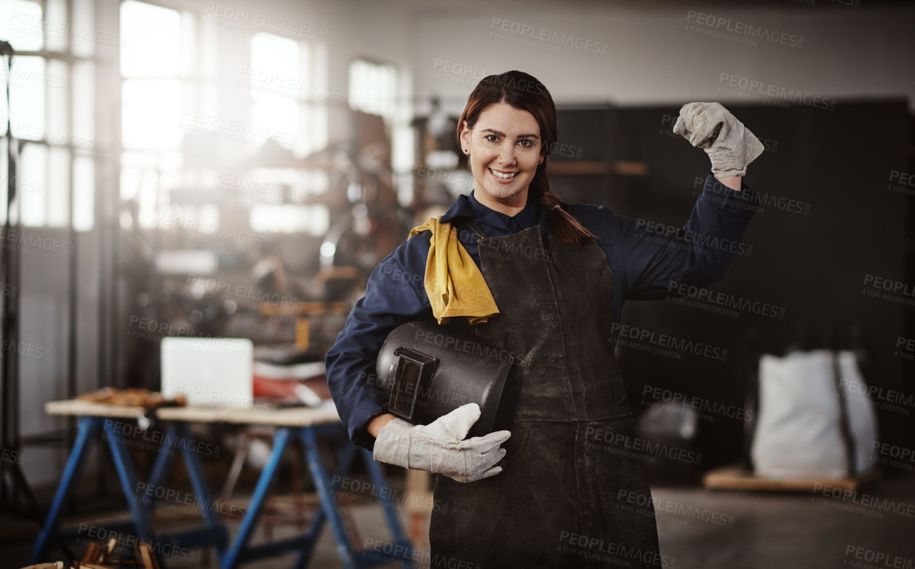 Buy stock photo Cropped portrait of an attractive young creative female artisan flexing in her workshop with her helmet tucked under her arm
