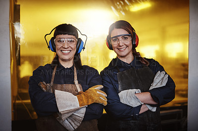 Buy stock photo Cropped portrait of two attractive young female artisans standing with their arms crossed in their workshop