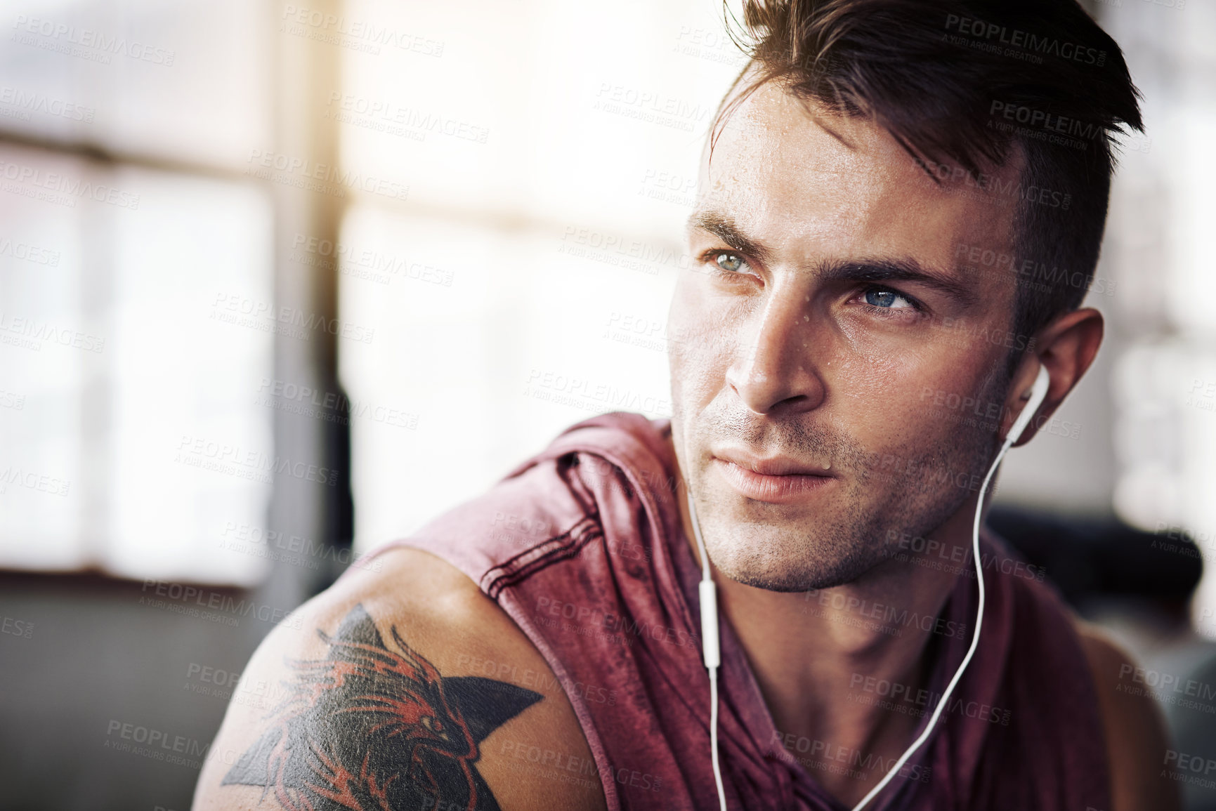 Buy stock photo Man, tired and music in gym for workout, exercise and wellness with radio for motivation. Training, thinking and male bodybuilder on break from cardio, fitness and earphones for listening to podcast