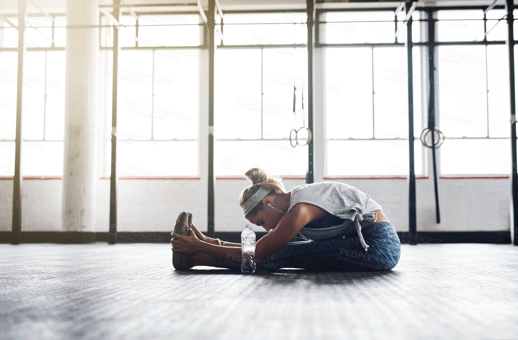 Buy stock photo Legs, stretching and workout with woman on floor of gym for health, muscle or wellness. Exercise, fitness and warm up for training with athlete getting ready for physical improvement routine