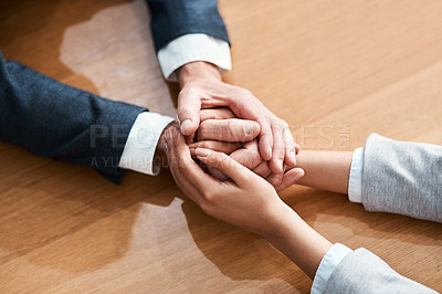 Buy stock photo Closeup shot of two unrecognizable businesspeople holding hands in an office