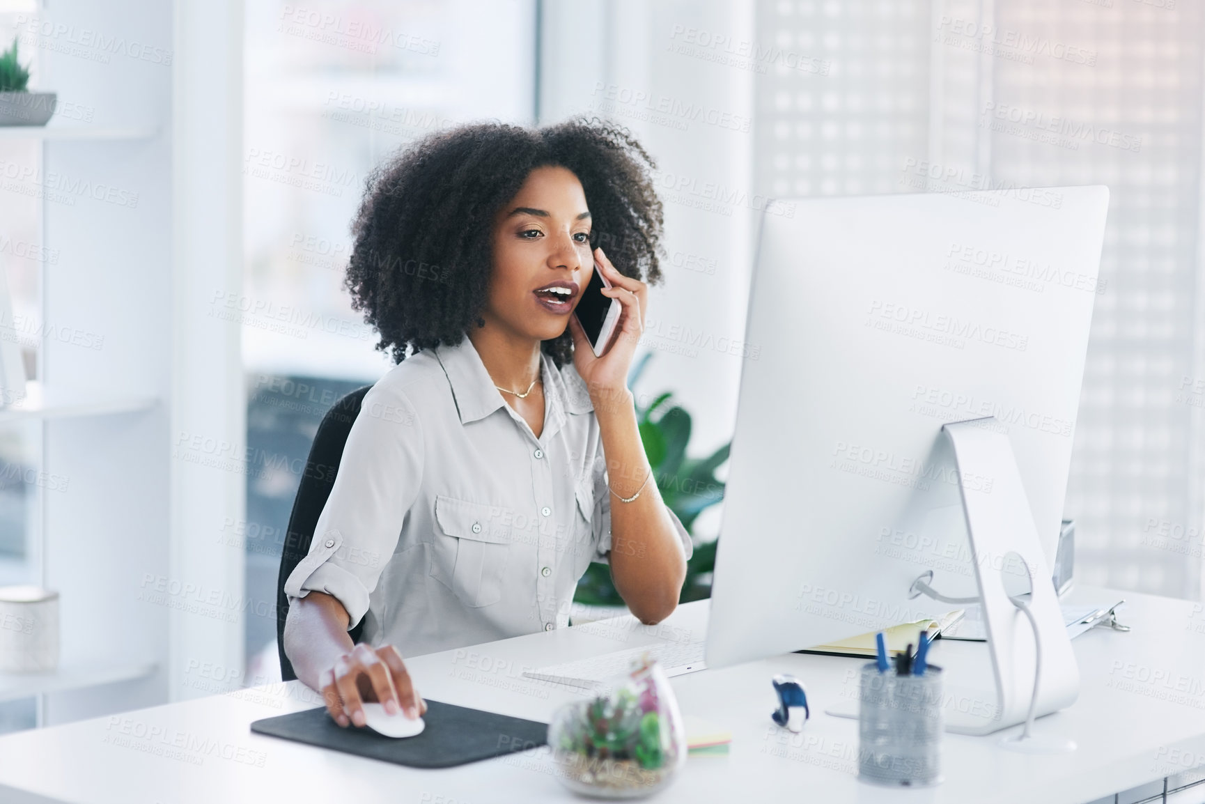 Buy stock photo Shot of a young businesswoman talking on a cellphone in an office