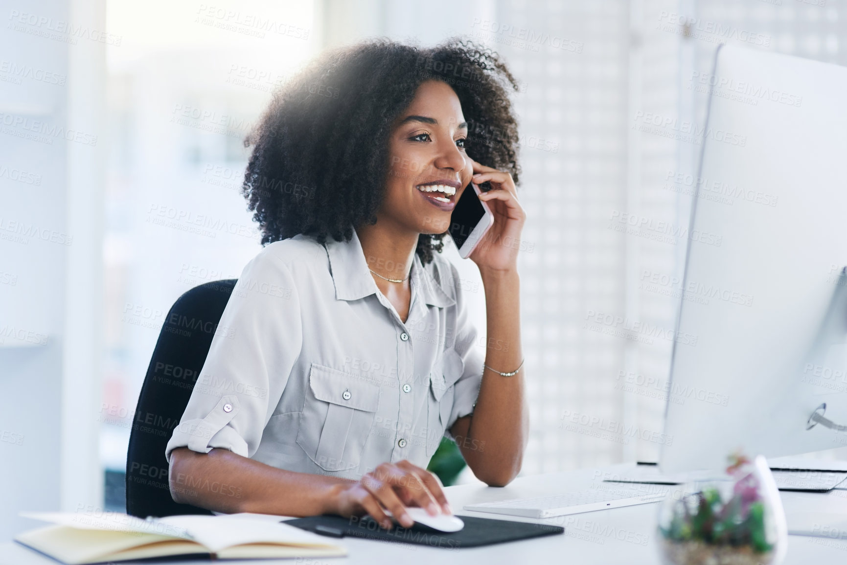 Buy stock photo Shot of a young businesswoman talking on a cellphone in an office