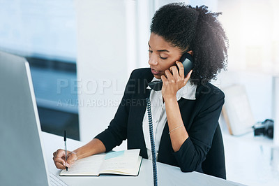 Buy stock photo Shot of a young businesswoman talking on a telephone in an office