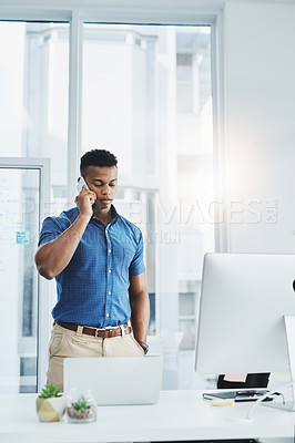 Buy stock photo Laptop, designer or black man on phone call in startup for planning, discussion or conversation at office. Listen, mobile and African consultant talking for tech agency, schedule or project ideas