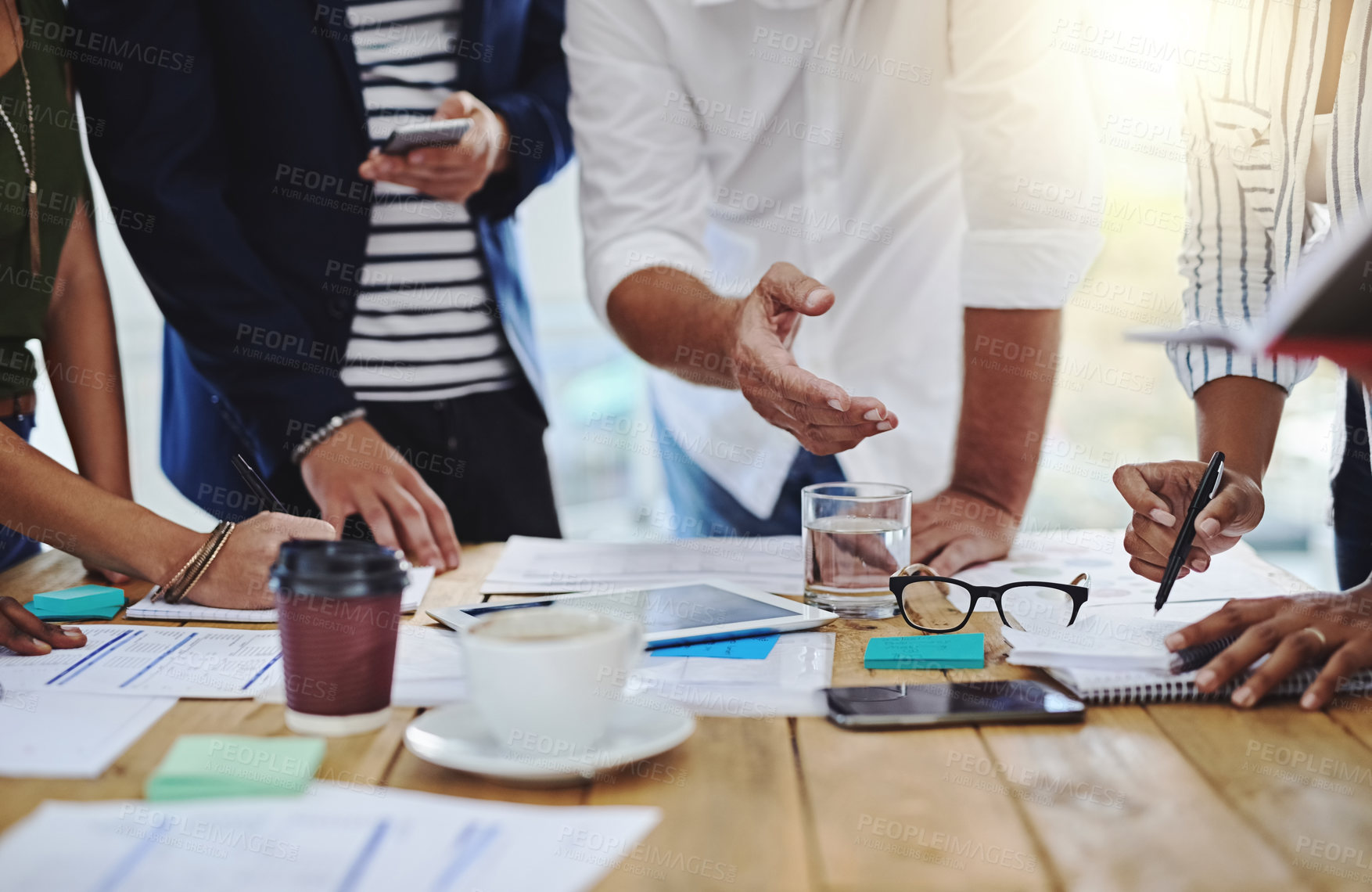 Buy stock photo Business people, hands and discussion with documents in collaboration or meeting for project at office. Group of employees in teamwork, conversation or discussing paperwork for brainstorming on desk